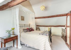 a bedroom with a bed and a dresser and a bed sidx sidx sidx sidx at The Loft in Rhayader