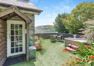 a garden with a white door and a patio at The Loft in Rhayader