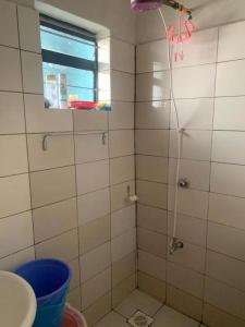a bathroom with a shower with a window at Rio-vista Apartments in Nairobi +10 photos
