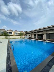 une grande piscine bleue en face d'un bâtiment dans l'établissement Monde Residence I no 6 Batam Centre, à Sengkuang