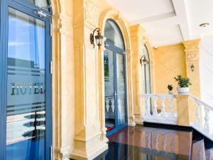 a balcony of a building with a blue door at Khách sạn Miami Ninh Thuận in Phan Rang–Tháp Chàm