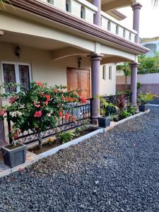 a house with a fence with flowers on it at Villa Bungaroo in Pereybere