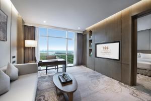Krevet ili kreveti u jedinici u objektu Grand Barony Qingdao Airport Hotel