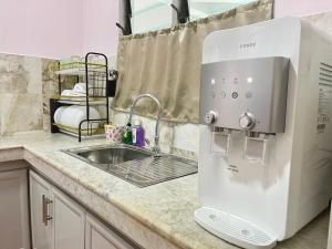 a kitchen counter with a mixer and a sink at Century Suria Aparment Langkawi by Zervin in Kuah +279 photos