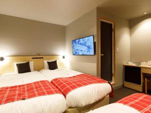 Un ou plusieurs lits dans un hébergement de l'établissement Hotel La Foresta By Rigna