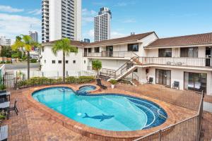 a swimming pool in front of a building at Gold Coast Inn in Gold Coast