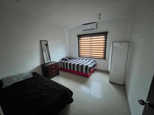 a room with two beds and a window in it at CASA EJECUTIVA in Reynosa