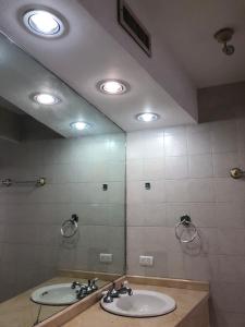 a bathroom with two sinks and a large mirror at CASA EJECUTIVA in Reynosa