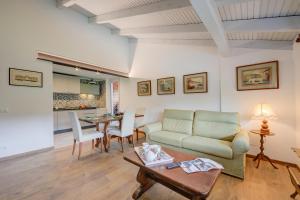 a living room with a couch and a table at Residenza La Lanterna Pool and Relax - Happy Rentals in Gignese