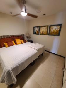 una camera con letto bianco e ventilatore a soffitto di Peninsula Condominiums, Hotel Zone, PV a Puerto Vallarta