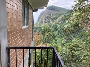 a balcony with a view of a mountain at Mountjoy Ella in Ella