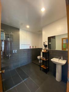 a bathroom with a sink and a shower and a toilet at Fantasy Lodge in Samboan