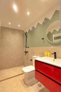 a bathroom with a white toilet and a sink at Atsiki's 54 apartments in Chios +85 photos