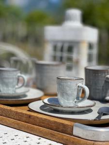 a group of cups and saucers on a table at Le Chalet de la Plage in Sévrier
