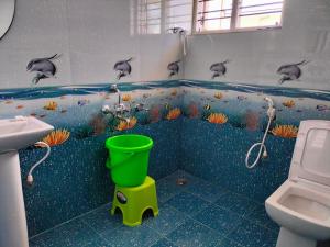a bathroom with dolphins on the wall of the tub at "SMS" HOME STAy in Kushālnagar +40 photos