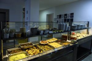 a buffet line with many different types of food at Sport Plaza Hotel & Apartments in Baku