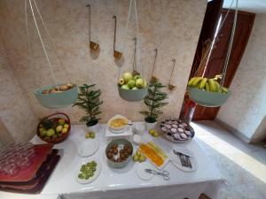 a table with bowls of fruit and plates of food at Hotel Palacio de la Magdalena in Soto del Barco