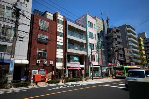a city street with a bus driving down the street at NEW! Pufuka Hikifune｜120㎡ (2 floors)｜Max 15 people in Tokyo