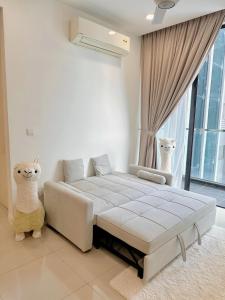 a white bedroom with a bed and a large window at MyHomeStay@JB LEGOLAND in Nusajaya