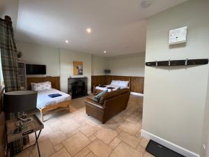 a hotel room with a bed and a couch at Traditional bothy accommodation in Blairgowrie