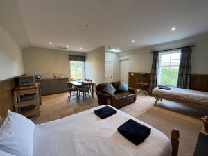 a bedroom with a bed and a living room at Traditional bothy accommodation in Blairgowrie