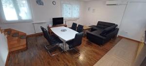 a room with a table and chairs and a couch at Vile Park Apartments Pula in Pula