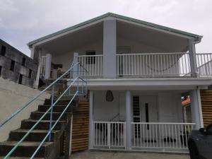 a house with a staircase in front of it at Résidence La Cafeiere in Saint-Claude