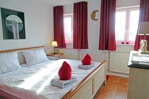 a bedroom with two santa hats on the bed at Auszeit Wormshöft in Hasselberg