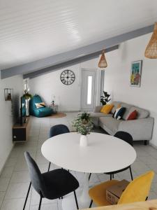 a living room with a white table and chairs at Résidence La Cafeiere in Saint-Claude