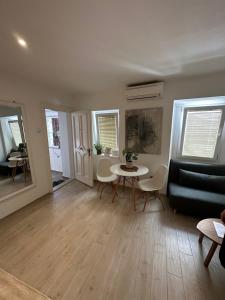 a living room with a table and a couch at Noelle apartment in Rovinj +27 photos