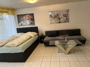a bedroom with two beds and a glass table at Linh's Ferienwohnung in Saarburg