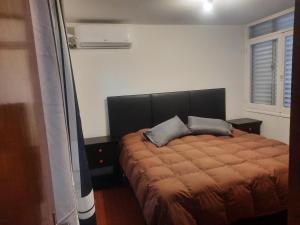 Un pat sau paturi într-o cameră la CONSORCIO ARIZU
