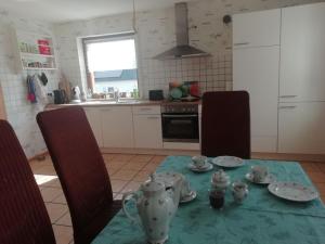 a kitchen with a table with plates and bowls on it at Ferienwohnung Link in Hellenthal