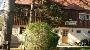 a building with a sign that reads northwestern village at NaturflairHaus in Königstein an der Elbe