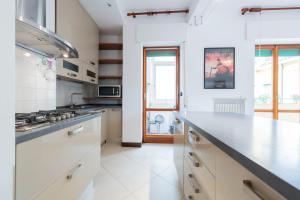 a kitchen with white cabinets and a counter top at Verona Movie Lovers in Verona