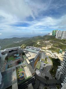 an aerial view of a city with buildings and mountains at Hilltop Cloud View Genting Luxury Suite in Genting Highlands