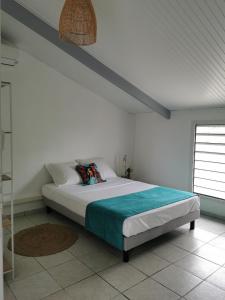 a bedroom with a bed in a white room at Résidence La Cafeiere in Saint-Claude