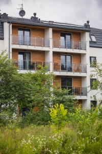 an apartment building with balconies on the side of it at Apartament w Dolinie Sanu nr 2 in Lesko