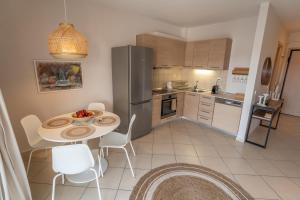 a kitchen with a table and a refrigerator at Elia Family Apartment in Neos Marmaras