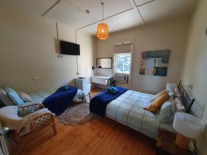 a bedroom with a bed and a living room at Pier Hotel in Port Lincoln