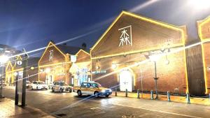 a car parked in front of a building at night at Rustic Modern House in Hakodate in Hakodate