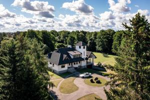 an aerial view of a house with a car parked in the driveway at Luxury Villa with 6 Bedrooms & Pool etc in Tallinn