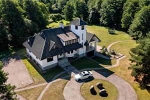 an aerial view of a house with a car on it at Luxury Villa with 6 Bedrooms & Pool etc in Tallinn