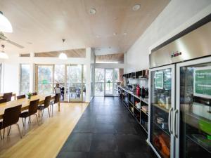 a dining room with a long table and chairs at YHA Apollo Bay Eco in Apollo Bay