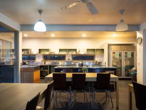 a large kitchen with a table and chairs at Apollo Bay Eco YHA in Apollo Bay