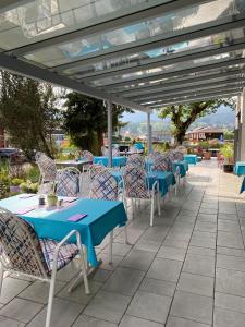 a row of tables and chairs under a pergola at Hotel Gasthof Adler in Oberstdorf