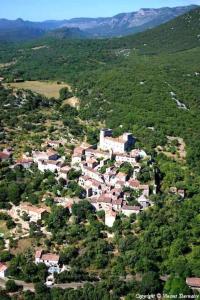 an aerial view of a village in the middle of a mountain at Gîte Thina in Brissac