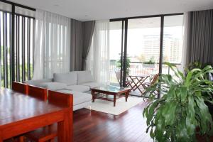a living room with a couch and a table at Davidduc's Apartment 5/41 Tay Ho in Hanoi