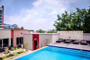 a swimming pool on the roof of a building with a house at Southern Sun Rosebank in Johannesburg