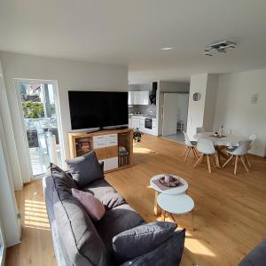 a living room with a couch and a table at Ferienapartment 21 in Kurort Gohrisch